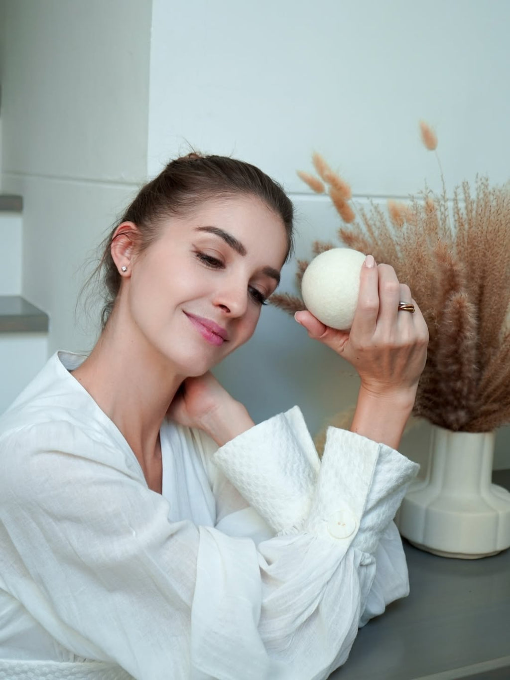 Woman holding dryer ball outdoors