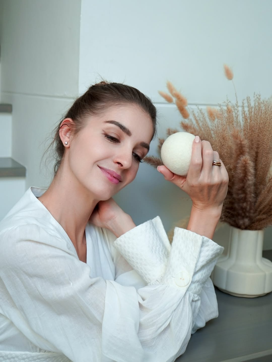 Woman holding dryer ball outdoors
